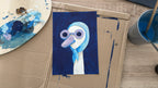 Painting of a cartoon character on cardboard with art supplies around
