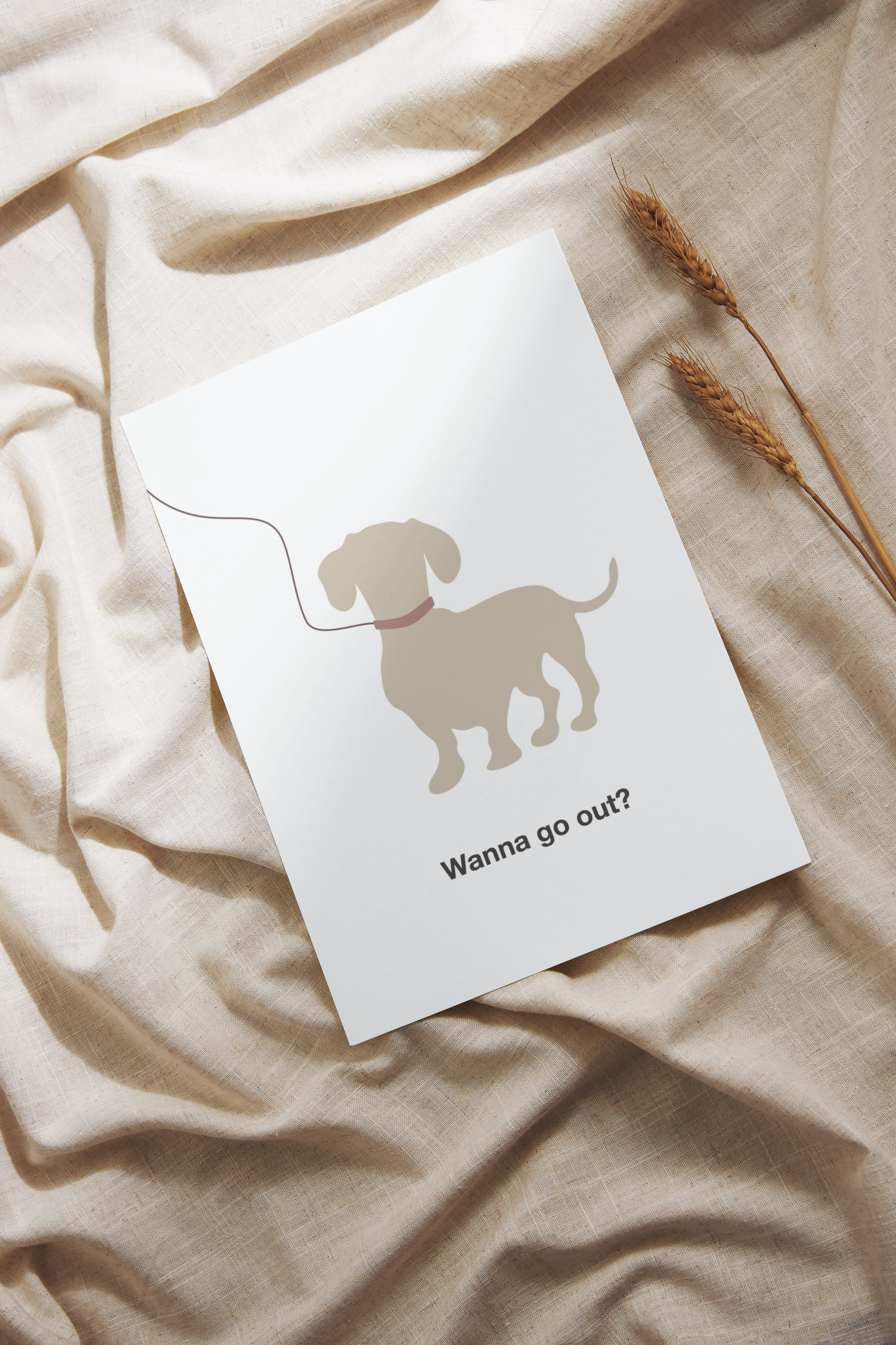 White card with a dog illustration and text 'Wanna go out?' on a beige fabric background
