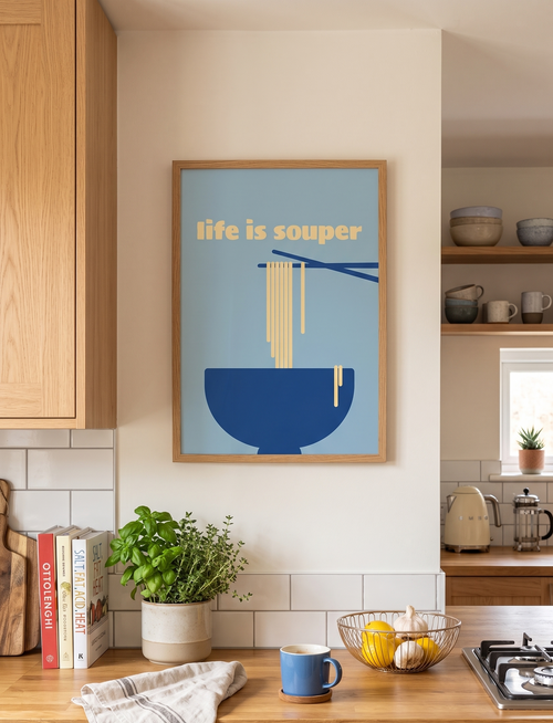 Kitchen interior with a framed poster reading 'life is souper' on the wall.